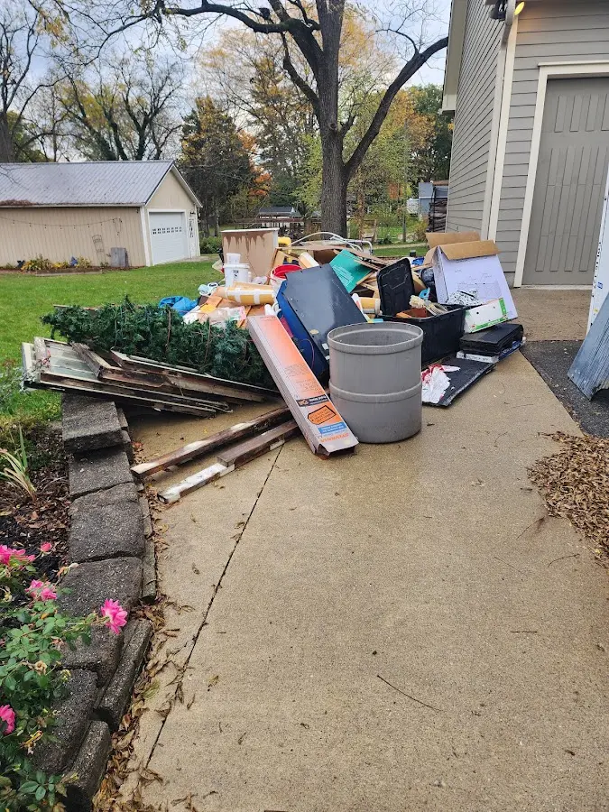 Dumpster being loaded with debris for Estate Cleanout Dumpster Rental in Moberly